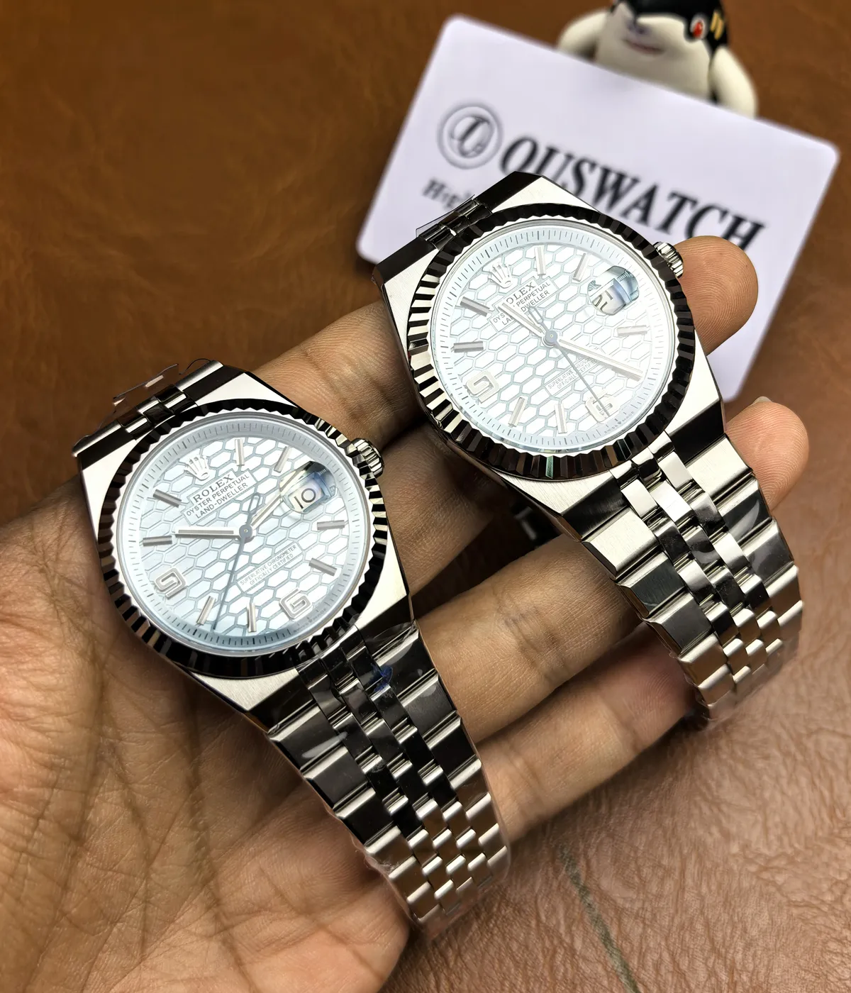 The Rolex Land-Dweller 127336-0001 with a platinum case, triangular grooved bezel, and ice blue honeycomb textured dial being worn on the wrist.