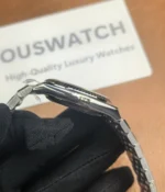 Side view showcasing the satin finish and triangular grooved bezel on the Rolex Land-Dweller 127334-0001 with a platinum case.