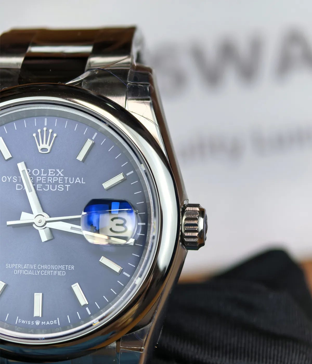 Close-up of the bezel details on the Rolex M276200-0006 28mm with a blue dial and Oyster steel strap.