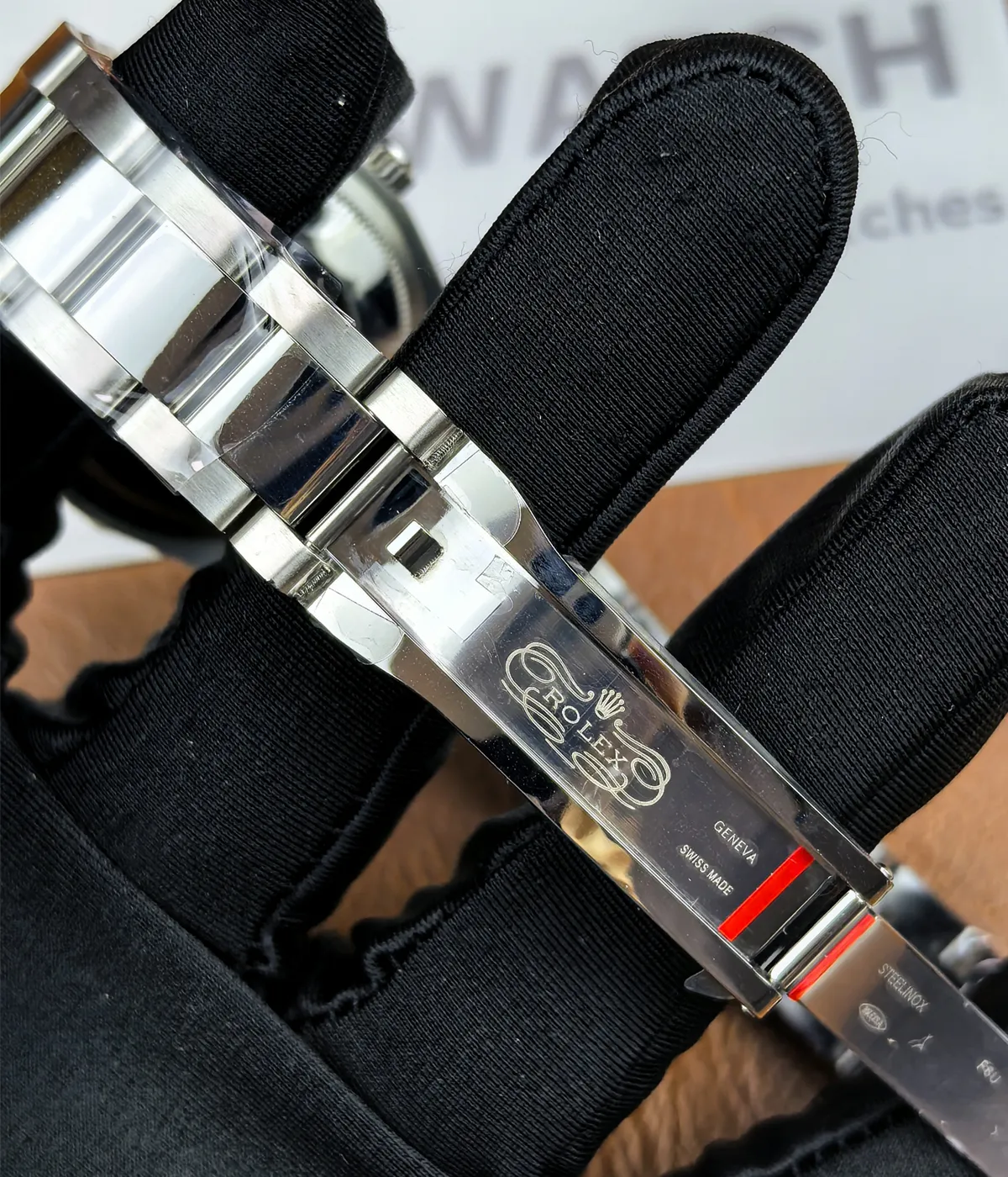 Close-up view of the logo inside the clasp of the Rolex M276200-0006 28mm with a blue dial and Oyster steel strap.