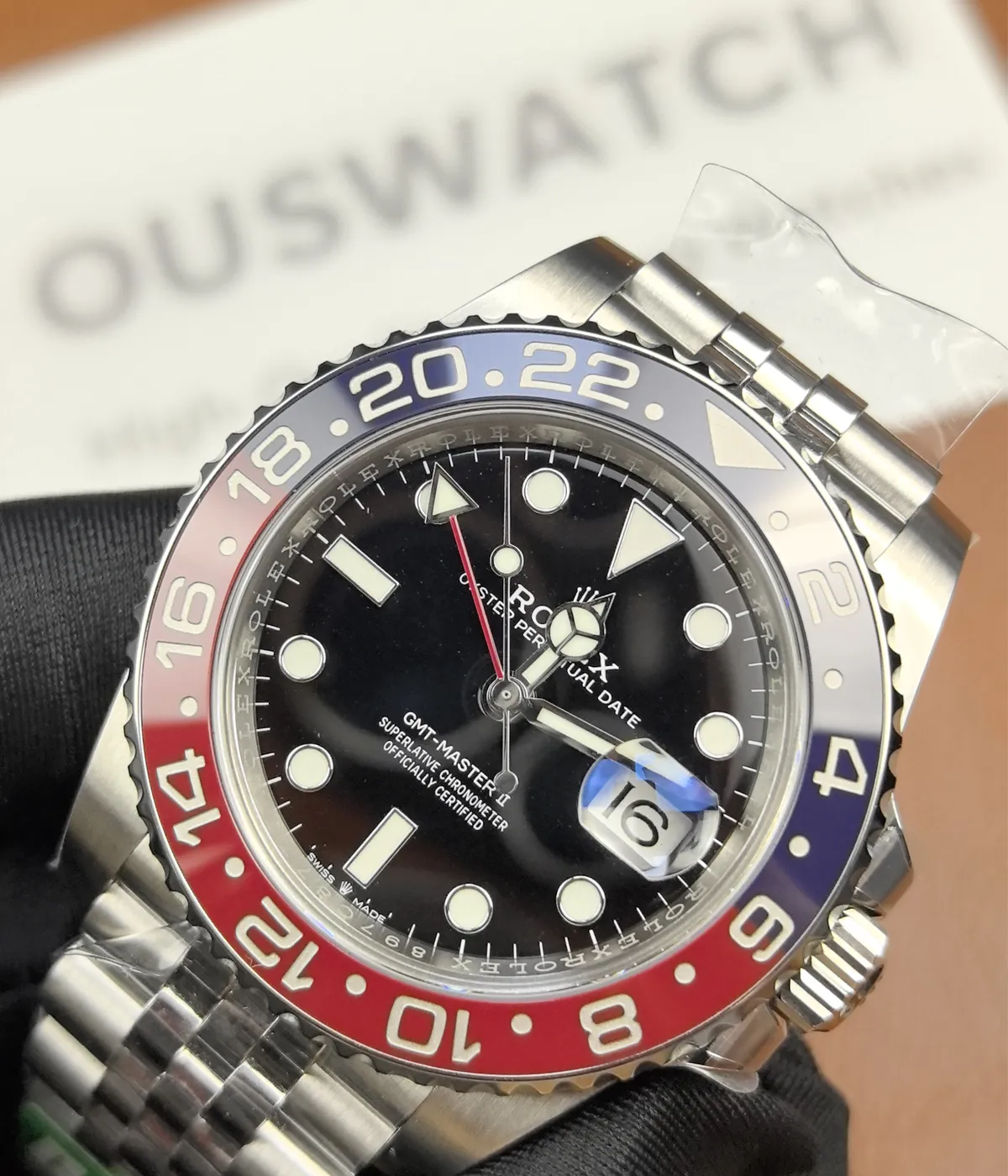 Close-up of the dial and bezel details on the Rolex Pepsi GMT-Master II M126719BLRO-0001 with a black dial and white gold case.