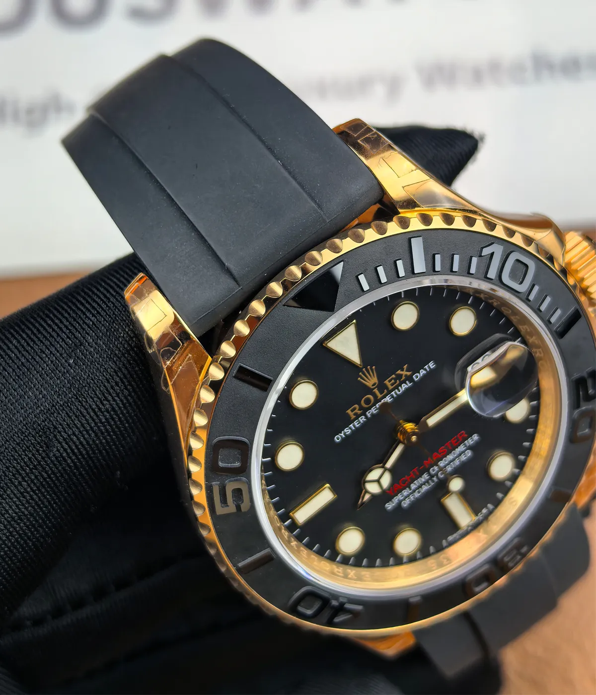 Close-up of the lugs on the Rolex Rose Gold Yachtmaster 126655-0002 with a 40MM black dial and rubber strap.