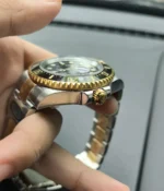 Close-up of the crown on the Rolex Sea Dweller M126603-0001 with a black dial and Oystersteel and yellow gold two-tone case.