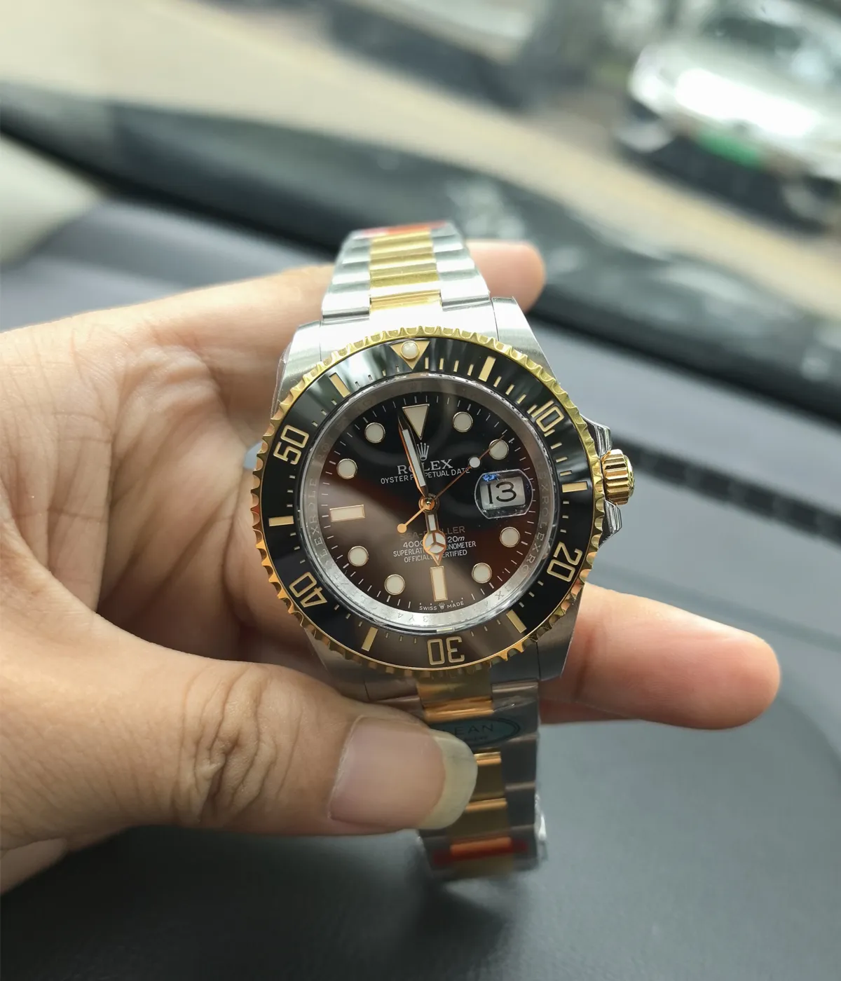 Close-up of the dial and bezel on the Rolex Sea Dweller M126603-0001 with a black dial and Oystersteel and yellow gold two-tone case.