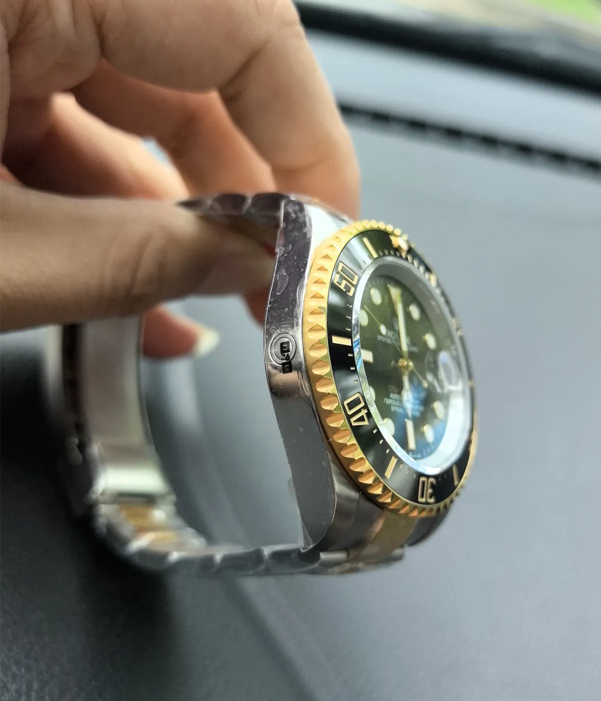 Close-up of the gold bezel on the Rolex Sea Dweller M126603-0001 with a black dial and Oystersteel and yellow gold two-tone case.