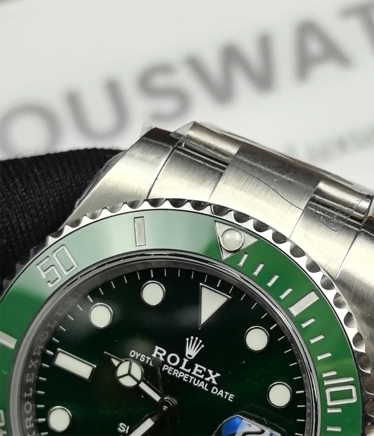 Close-up view of the bezel on the Rolex Submariner Date 116610LV-0002 with a 40MM green dial and Oystersteel case.