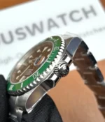 Close-up of the crown on the Rolex Submariner Date 116610LV-0002 with a 40MM green dial and Oystersteel case.