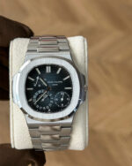 Front view of the Patek Philippe Nautilus 5712-1A featuring a steel case and blue luminous dial.