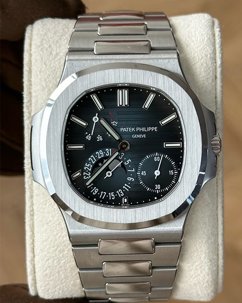 Front view of the Patek Philippe Nautilus 5712-1A featuring a steel case and blue luminous dial.