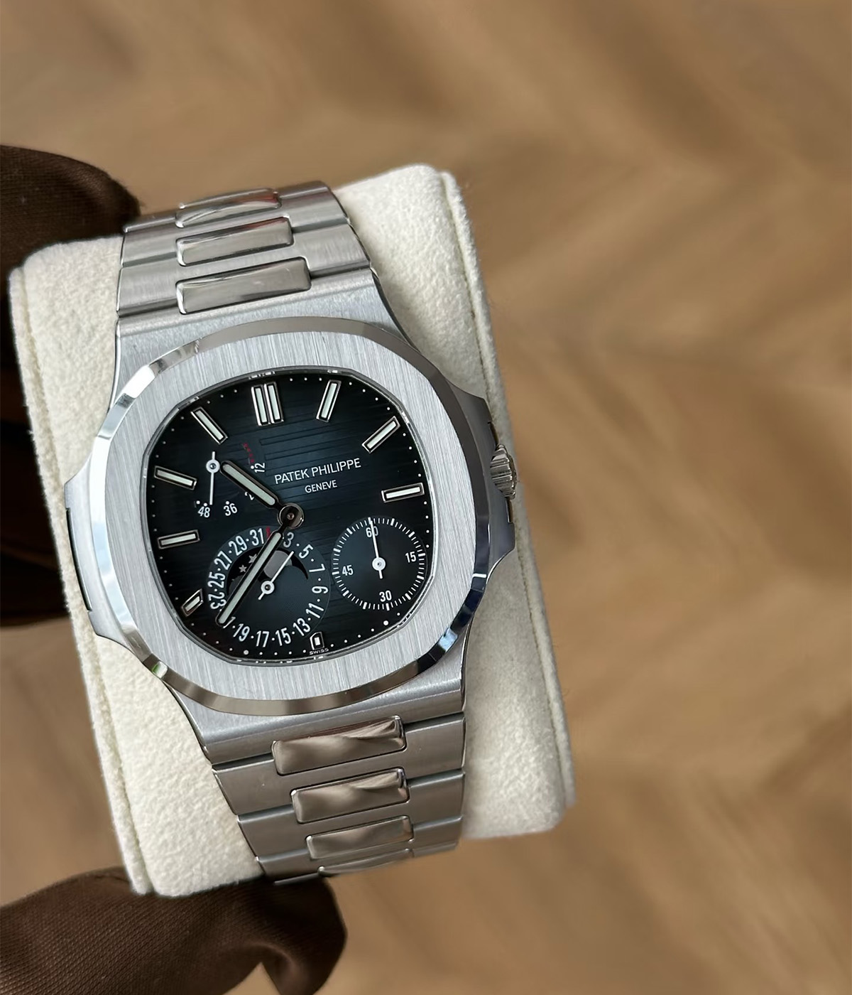 15-degree angled view of the Patek Philippe Nautilus 5712-1A with a steel case and blue luminous dial.
