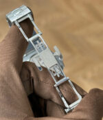 Clasp display of the Patek Philippe Nautilus 5712-1A with a steel bracelet and blue luminous dial.